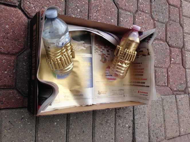 This is how I spray painted them - wrapping them around the bottle was an ingenious idea my dad came up with - props to him.  